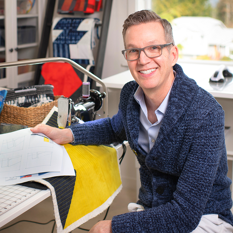 Photo of guest speaker David Owen Hastings sitting at his featherweight sewing machine