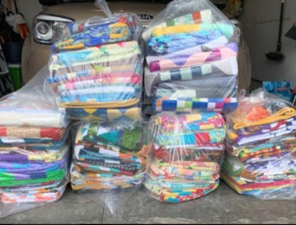 colourful quilts in clear bags, bundled and ready for delivery