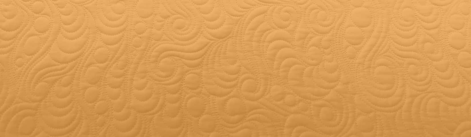 Texture of quilting on an orange background