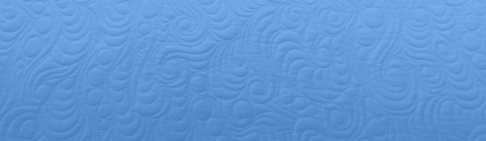 Texture of quilting on an azure background